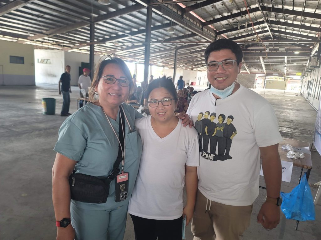 Dr. Luz with two workers